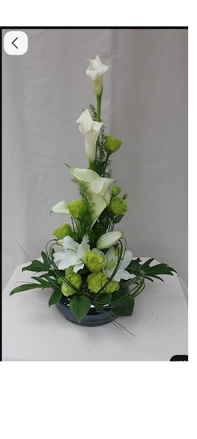 White lilies in green ceramic pot