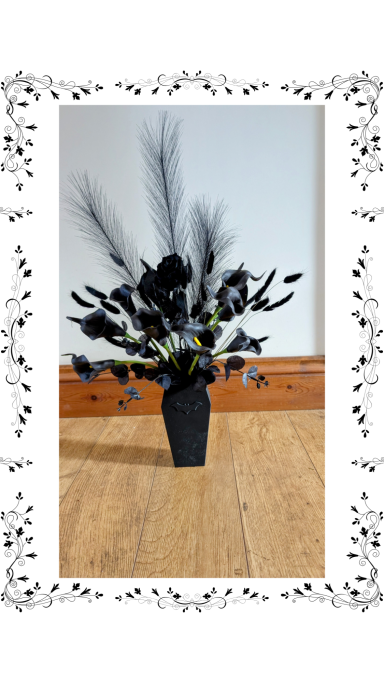 Black roses in coffin vase